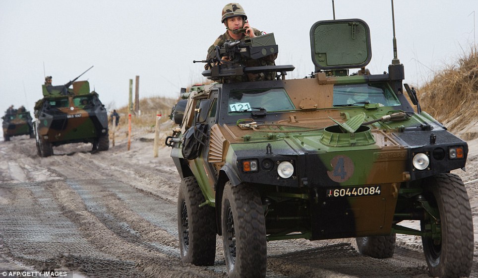 Scale: Troops carriers drive along the beach after making landfall as 20,000 service personnel, including Marines, sailors and air staff, take part in the operation